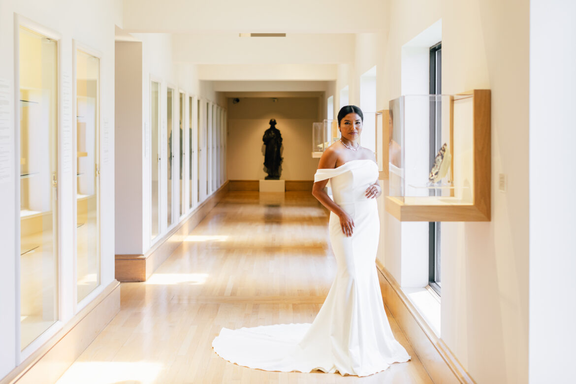 A Southern bride wearing a gown from McClendon Bridals admires the art in the Montgomery Museum of Fine Arts