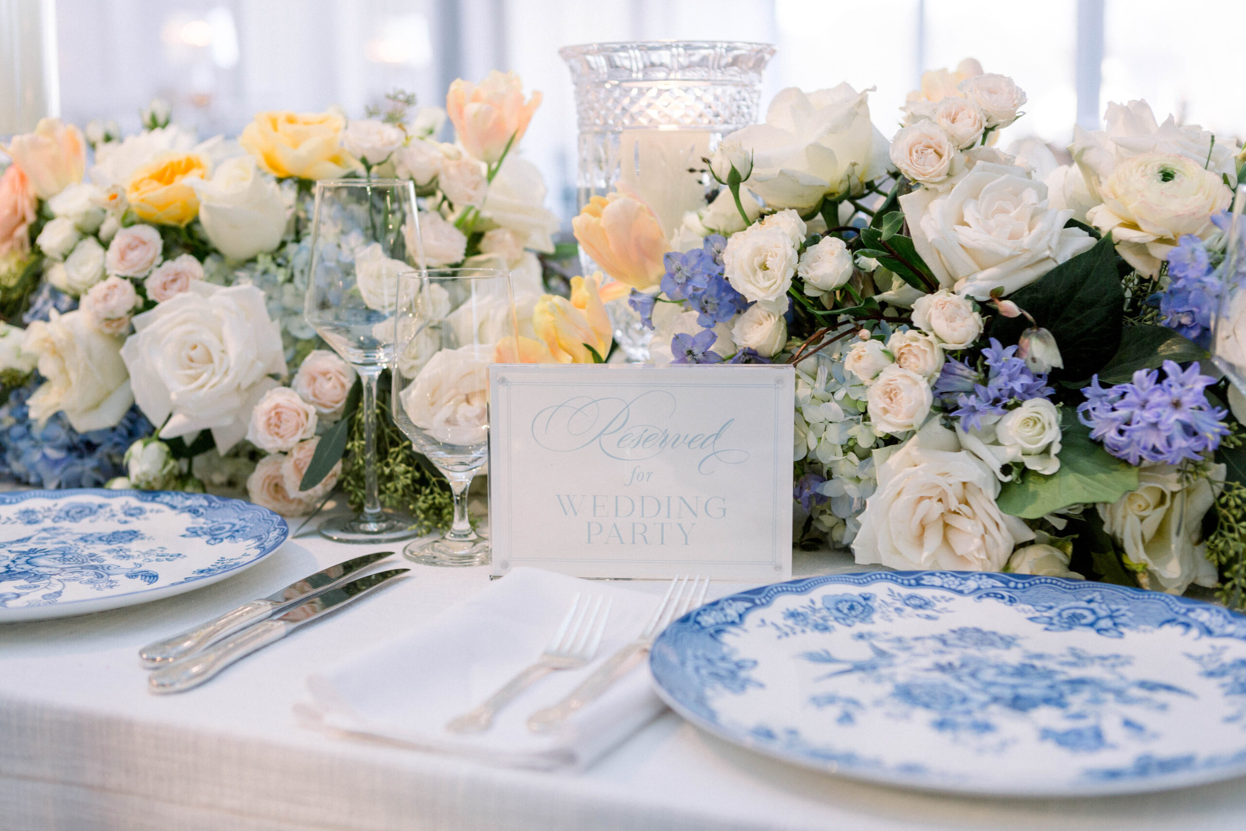 The head table for this Southern summer wedding features a mix of flowers.