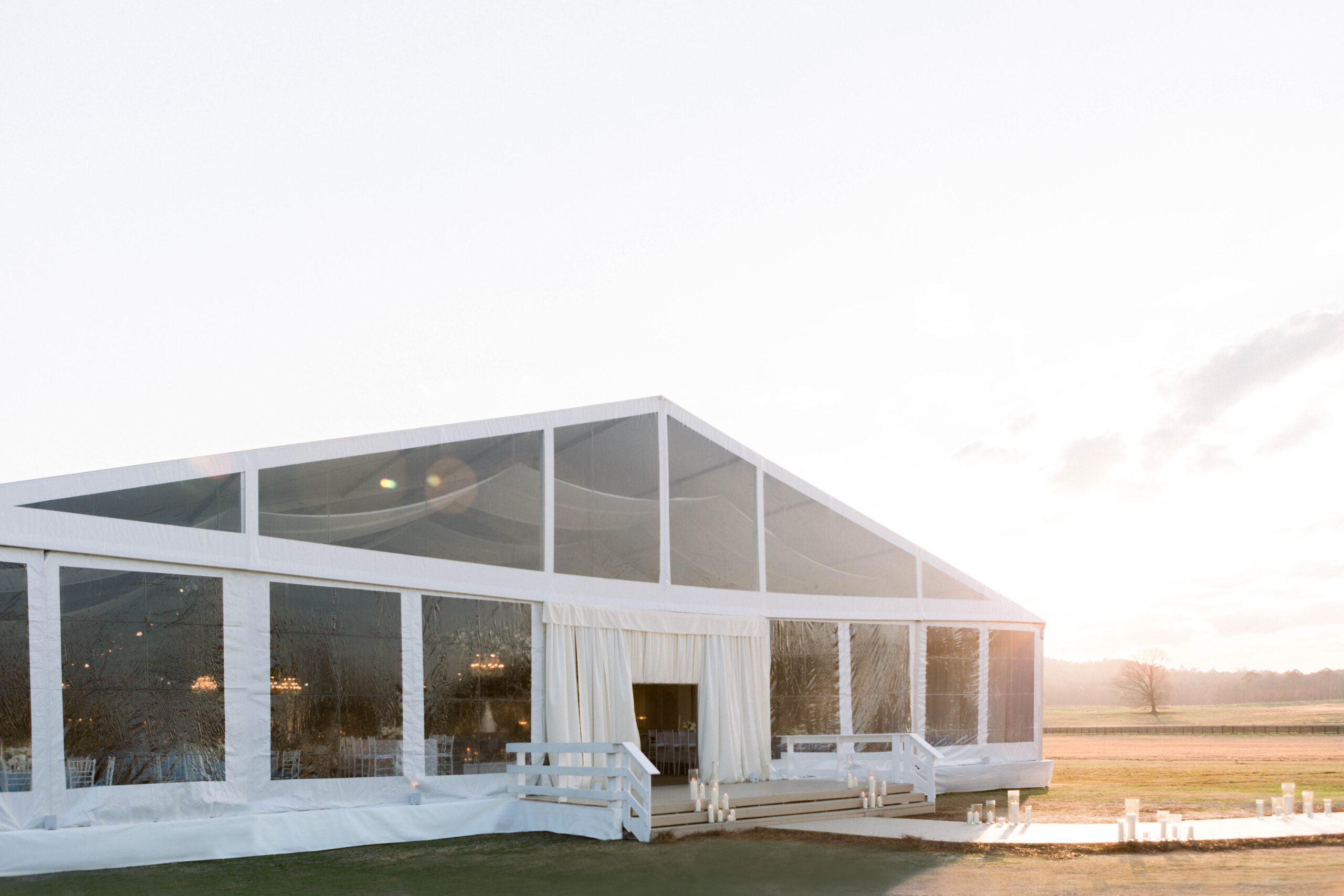 The sun begins to set on this tented wedding reception at Pursell Farms.