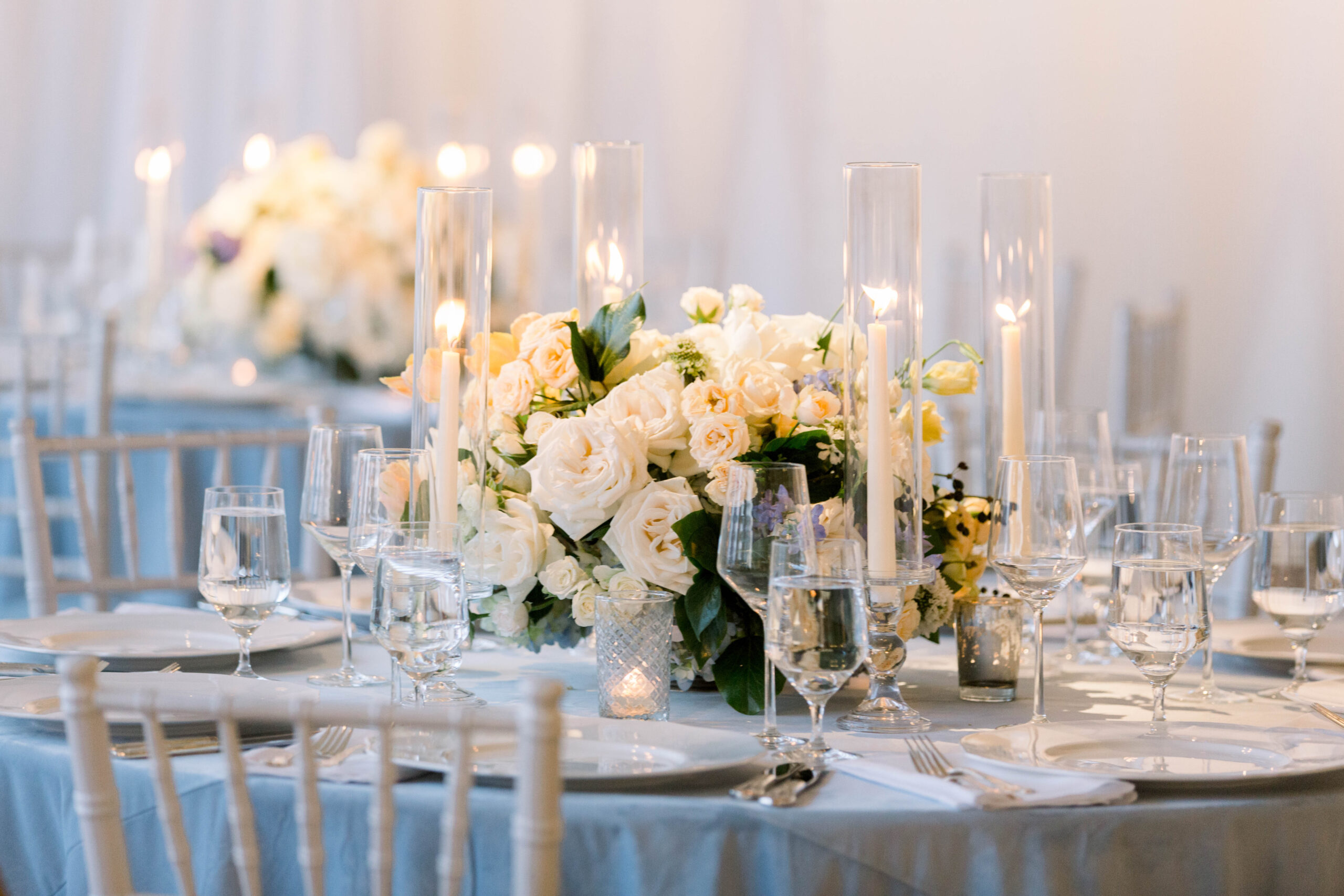 The centerpiece for this Southern summer wedding features flowers by CeCe Designs an candlesticks.