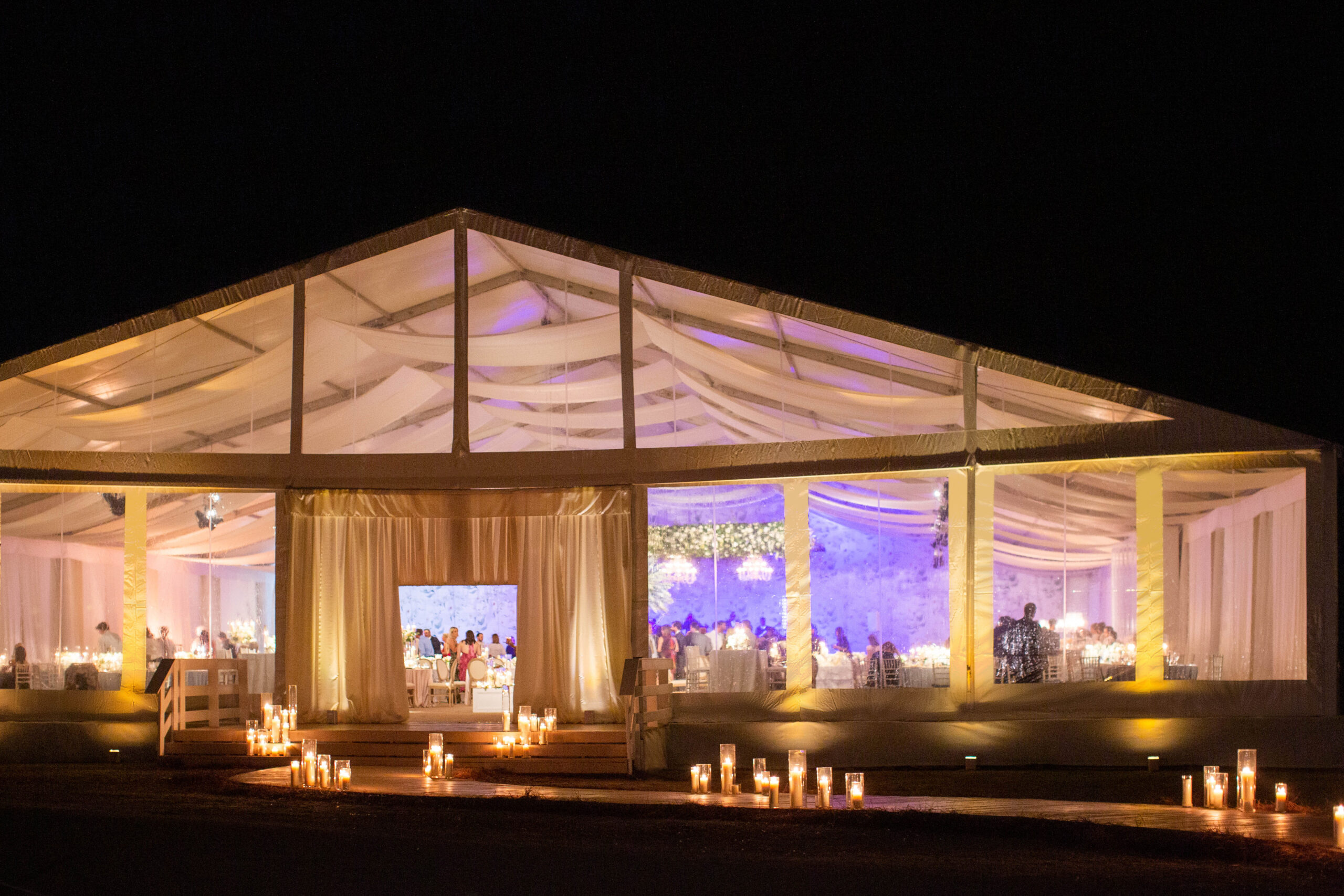 A tent reception glows at night at Pursell Farms in Alabama.