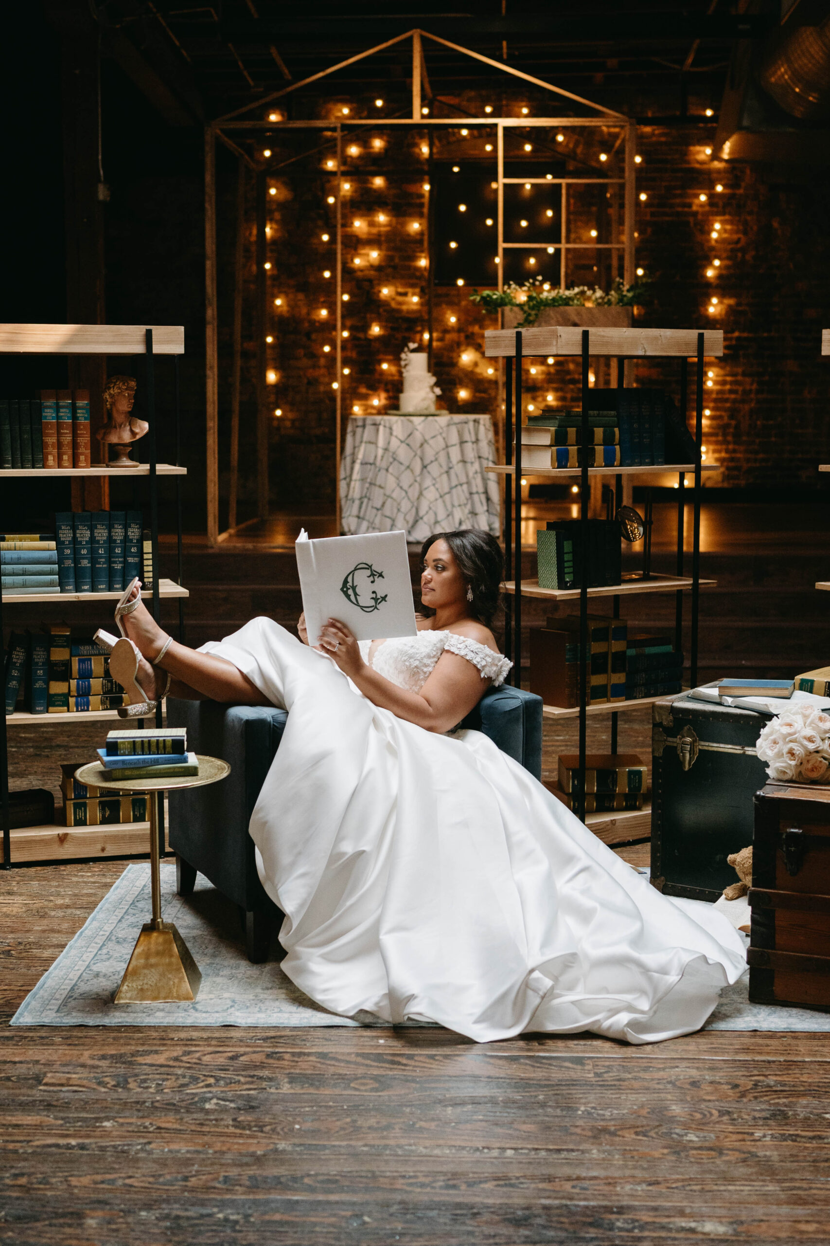 The bride reads a guest book by Charming Scribe at B&A Warehouse in Birmingham.