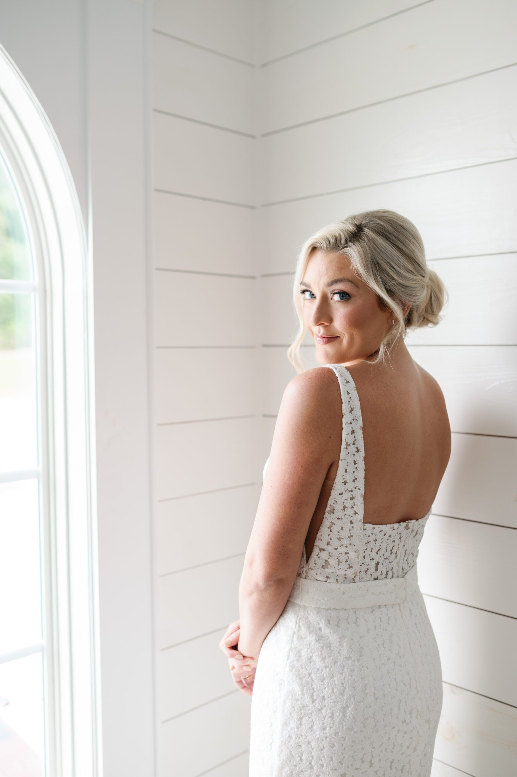 A Southern bride poses in her wedding dress from Bella's Bridal & Formal at Oak Meadow in Ohatchee, Alabama.