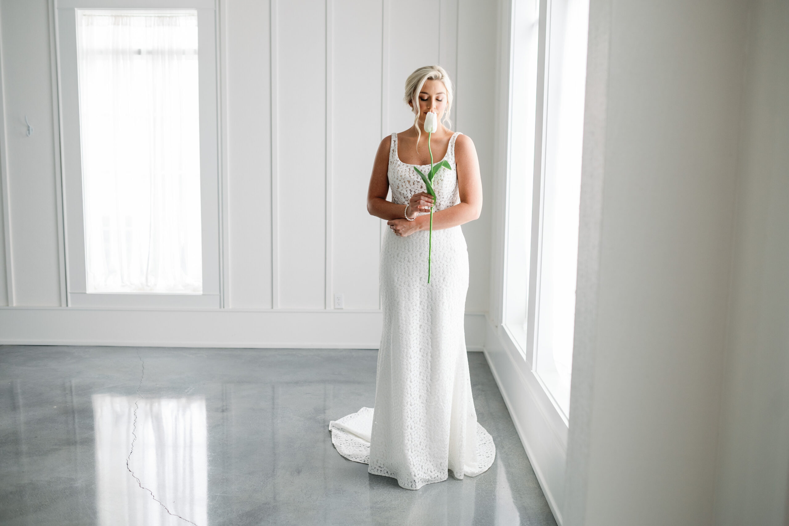 A Southern Bride stands in the bright and light venue setting of Oak Meadow Event Center.