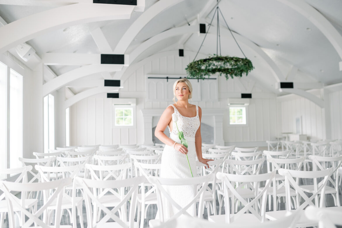 A Southern Bride stands in the bright and light venue setting of Oak Meadow Event Center.