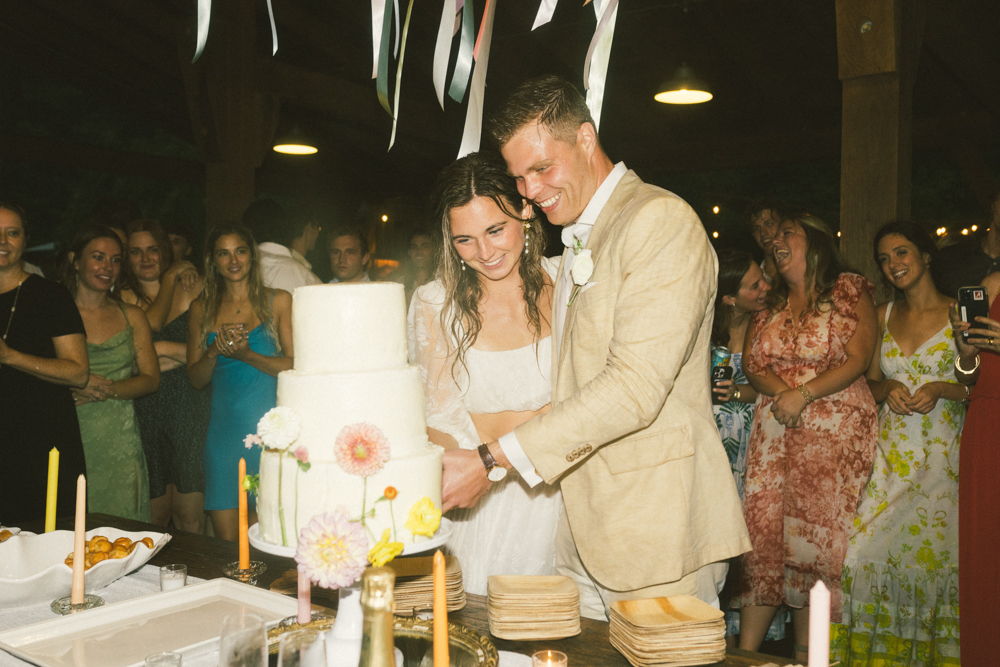 The bride and groom cut the cake during their Alabama wedding reception.