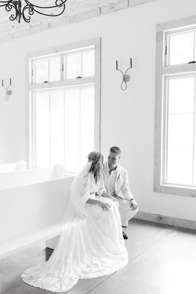 The bride and groom talk with each other on their wedding day.