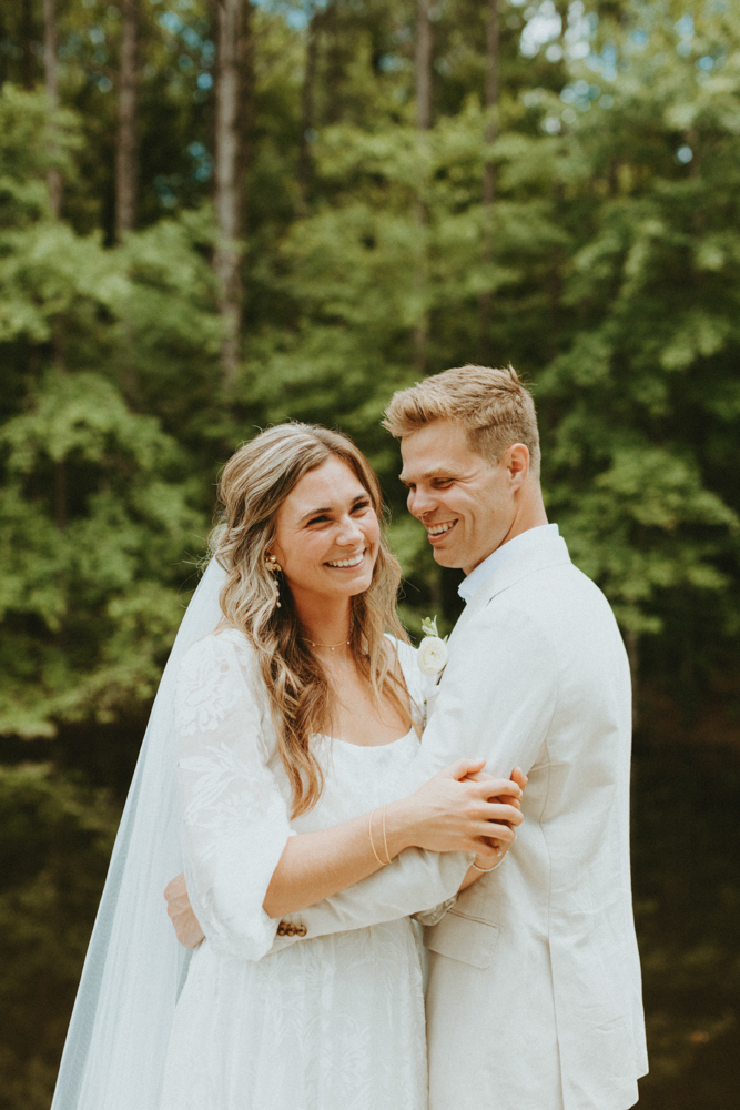 The bride and groom smile together before their Alabama wedding.