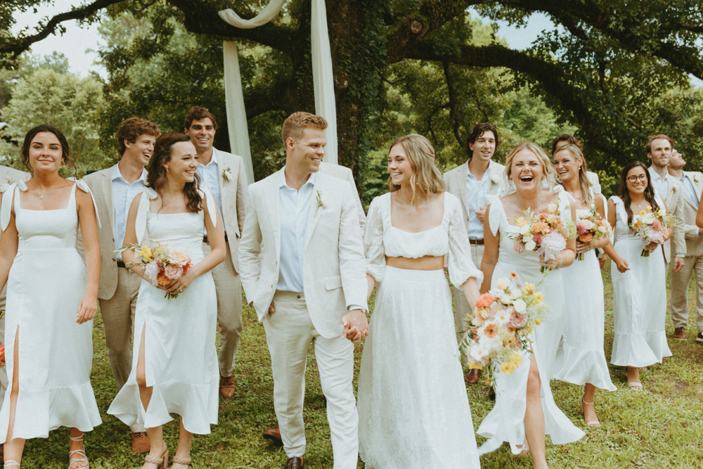 The wedding party laughs together as they walk to the Alabama wedding ceremony.