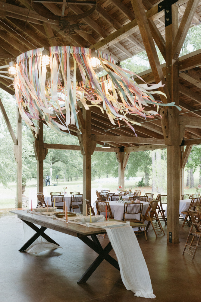 Pastel streamers blow in the wind on the pavilion during an Alabama wedding reception.