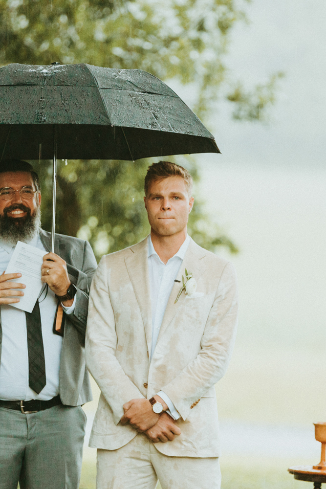 The groom tears up as he sees his bride before the rainy wedding ceremony.