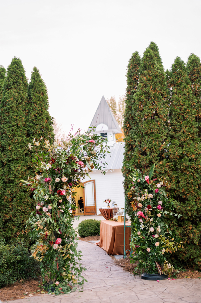 A floral arch decorates the entrance to this Alabama wedding at The Sonnet House.