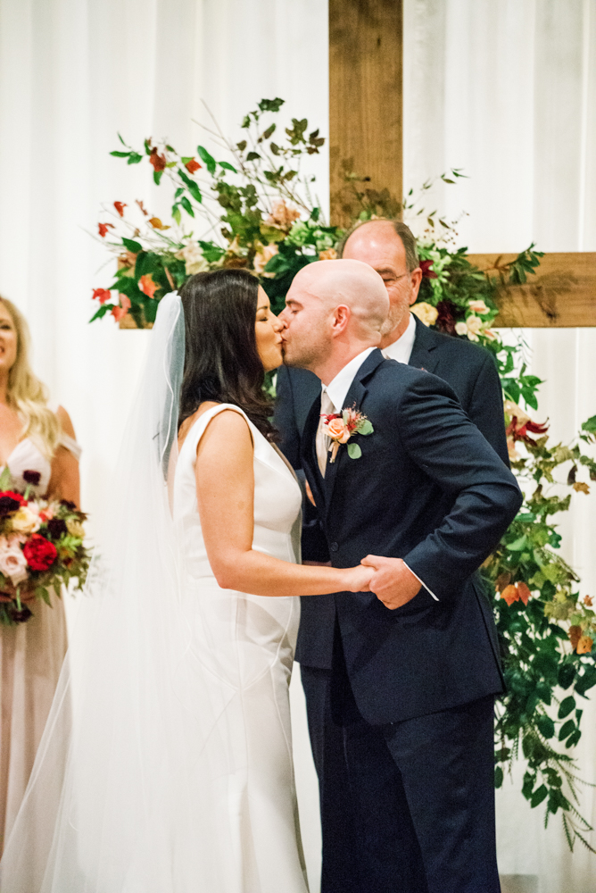 The bride and groom kiss at their Southern wedding ceremony.