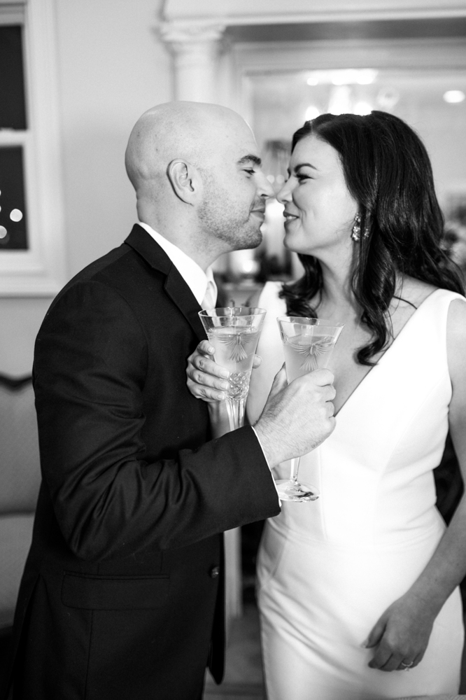 The bride and groom share a champagne toast during their Birmingham wedding reception.