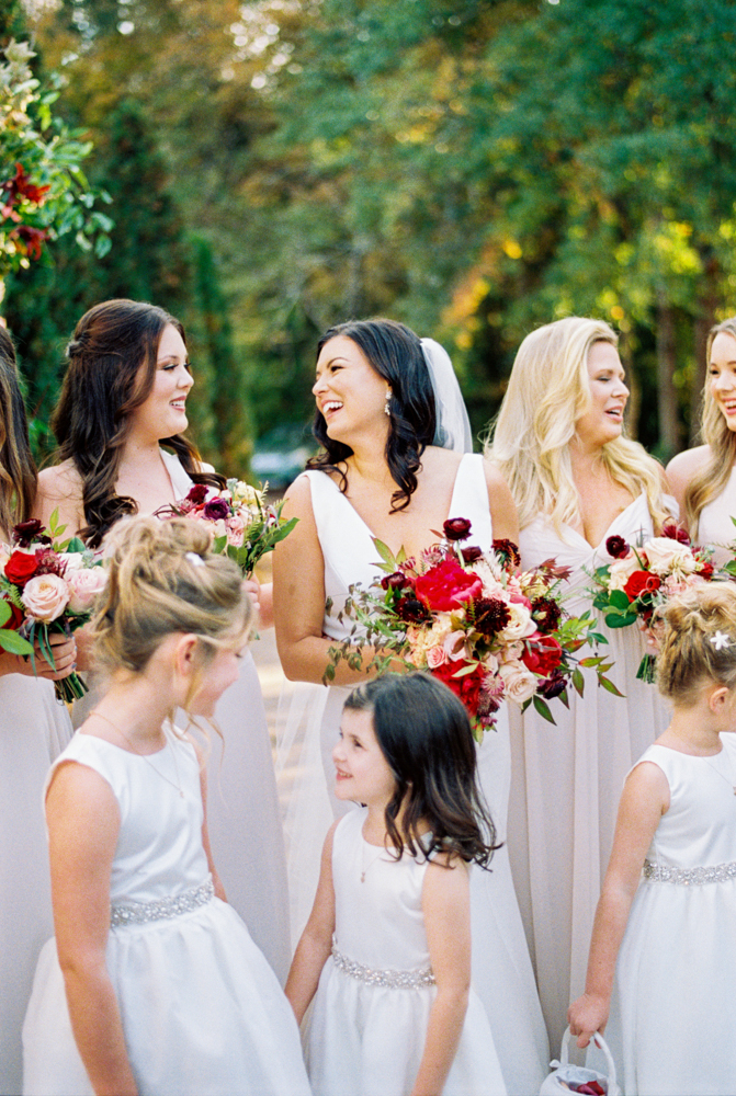 The bride laughs with her bridal party at this fall wedding in Birmingham, Alabama.