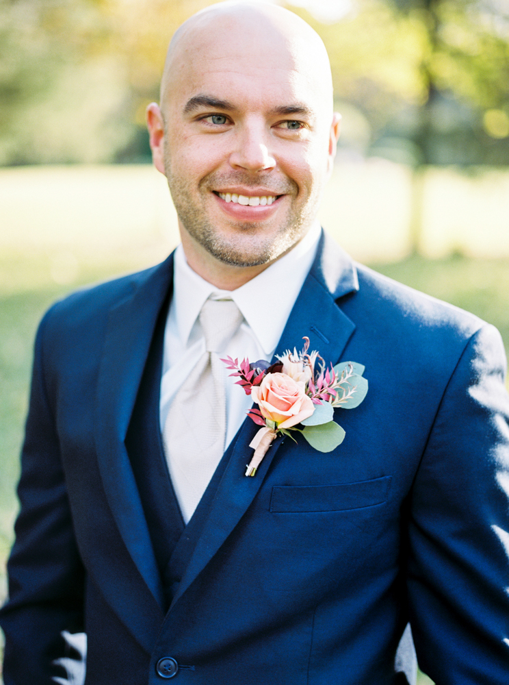 The groom is photographed with his boutonniere prior to his Southern wedding ceremony.