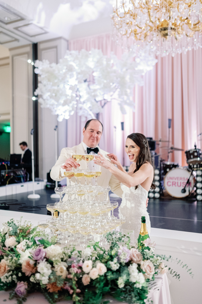 The bride and groom enjoy their champagne tower during their Birmingham wedding reception at Grand Bohemian Hotel Mountain Brook.