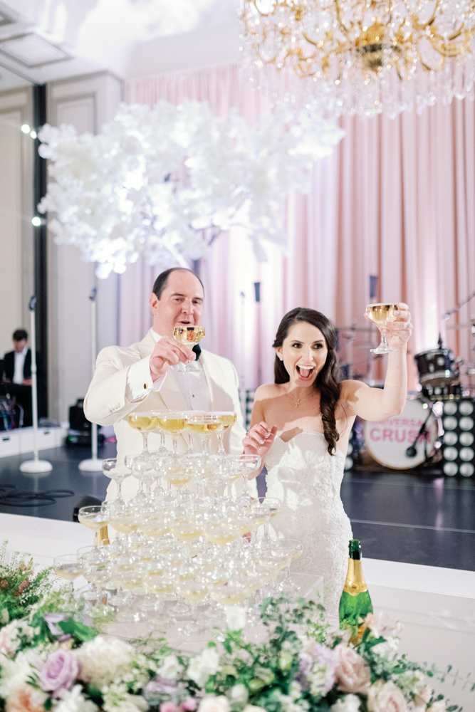 The bride and groom enjoy their champagne tower during their Birmingham wedding reception at Grand Bohemian Hotel Mountain Brook.