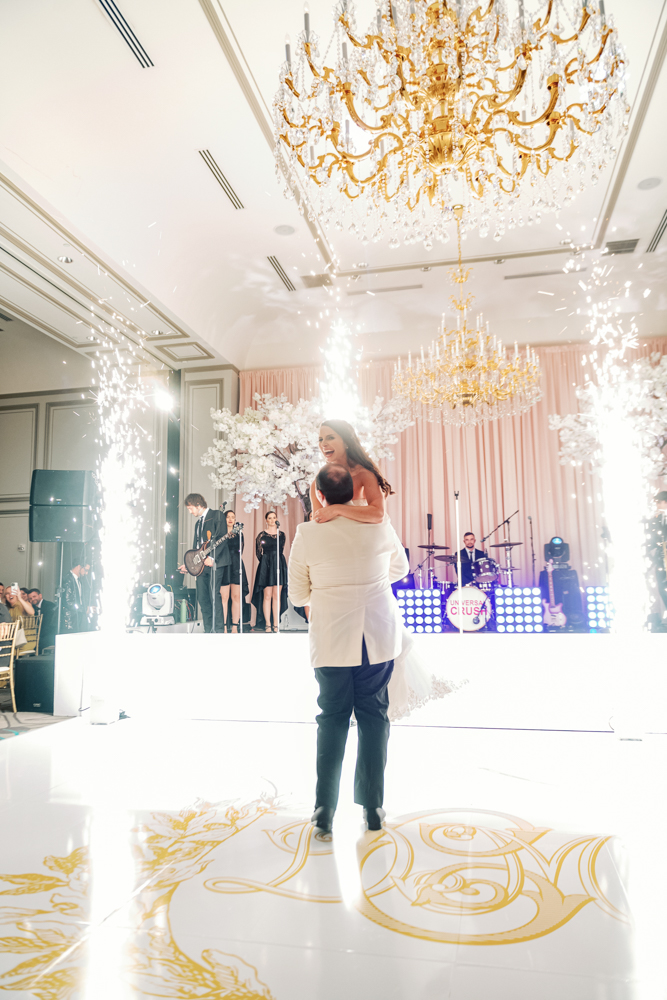 The groom lifts the bride during the first dance at Grand Bohemian Hotel Mountain Brook.