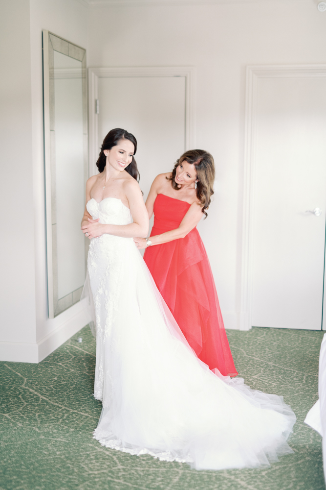 The mother of the bride helps her daughter into her wedding dress at Grand Bohemian Hotel Mountain Brook.