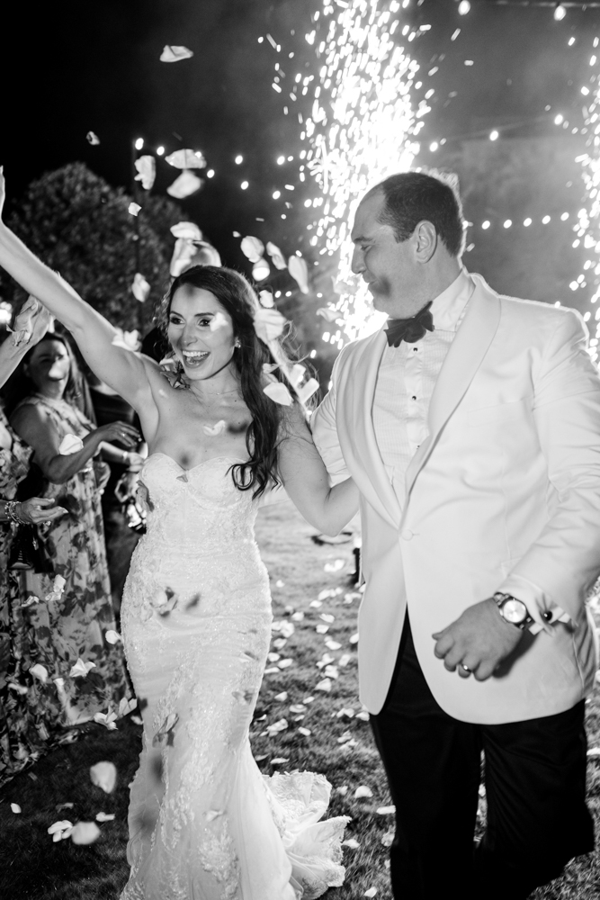 The bride and groom exit the wedding reception at Grand Bohemian Hotel Mountain Brook.