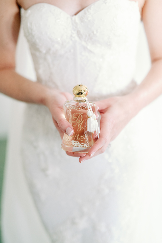 The bride holds her custom perfume for her wedding day at Grand Bohemian Hotel Mountain Brook.