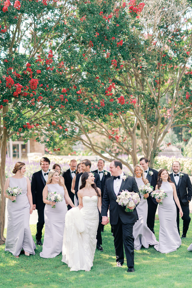 The wedding party walks together at Birmingham Botanical Gardens.