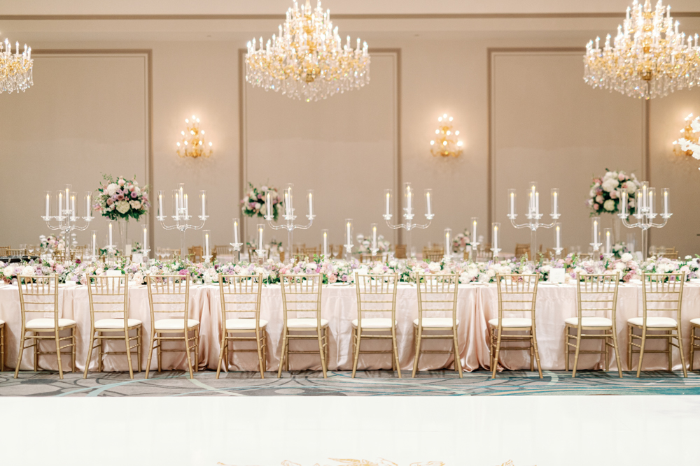 The tablescape at Grand Bohemian Hotel Mountain Brook features candelabras and spring flowers under chandeliers.