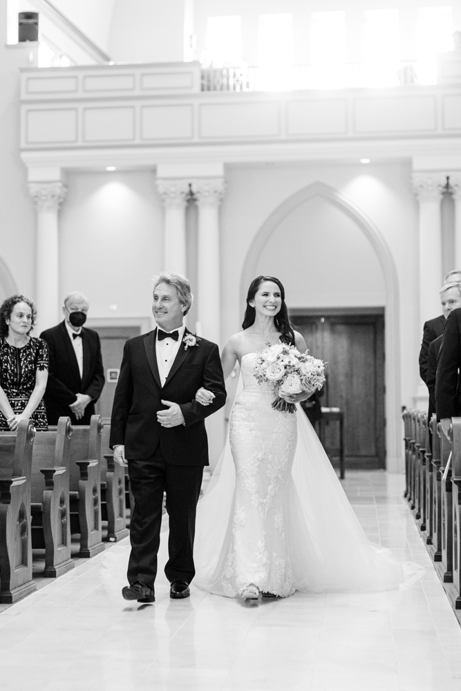 The father of the bride walks the bride down the aisle of this Birmingham wedding ceremony.