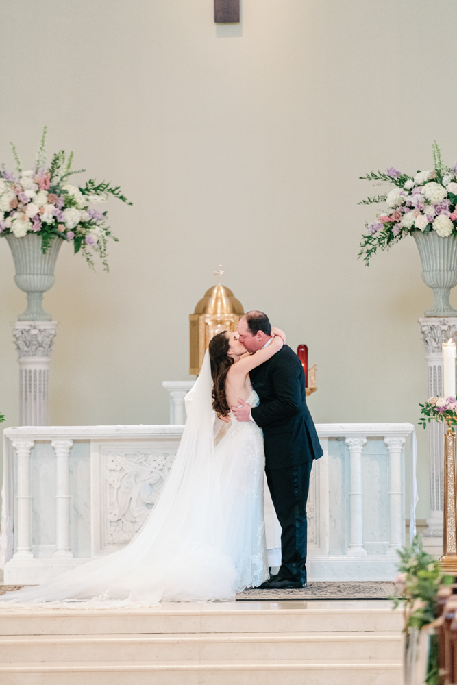 The bride and groom kiss during their Birmingham wedding ceremony in Alabama.