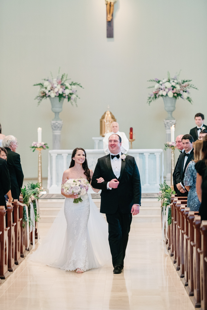 The bride and groom exit their Birmingham wedding ceremony together.