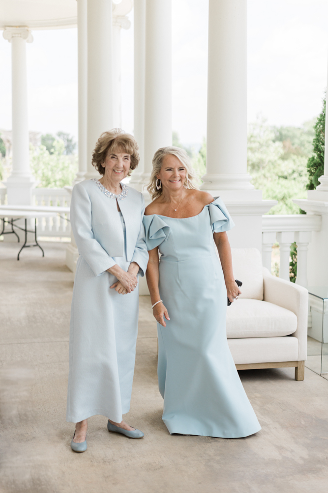 The mother and grandmother wear something blue as they admire the bride at Huntsville Botanical Garden.