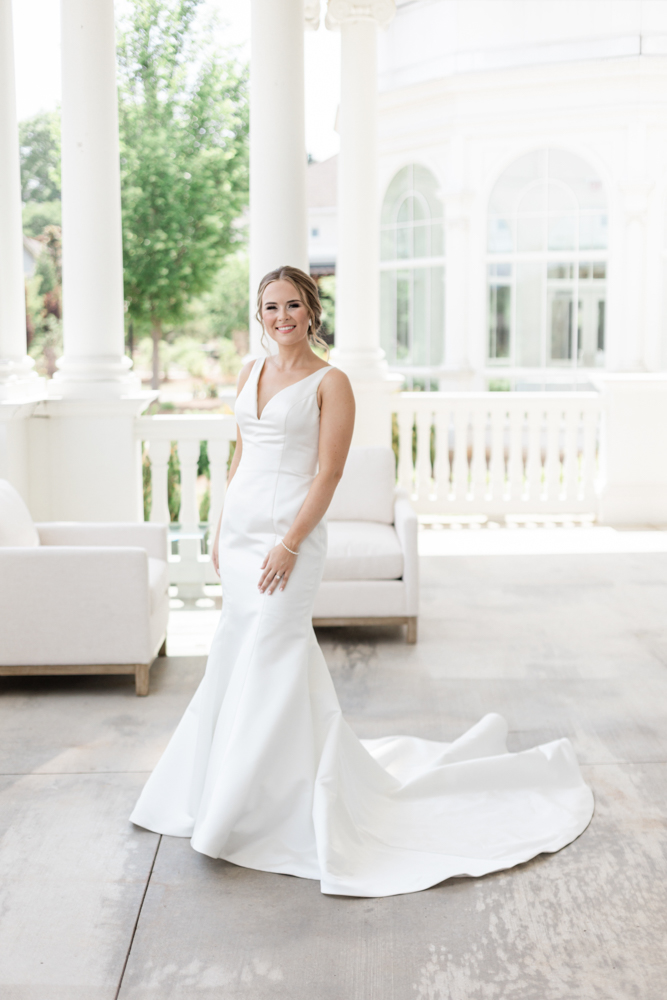 The bride poses on the veranda on a beautiful day at Huntsville Botanical Garden.