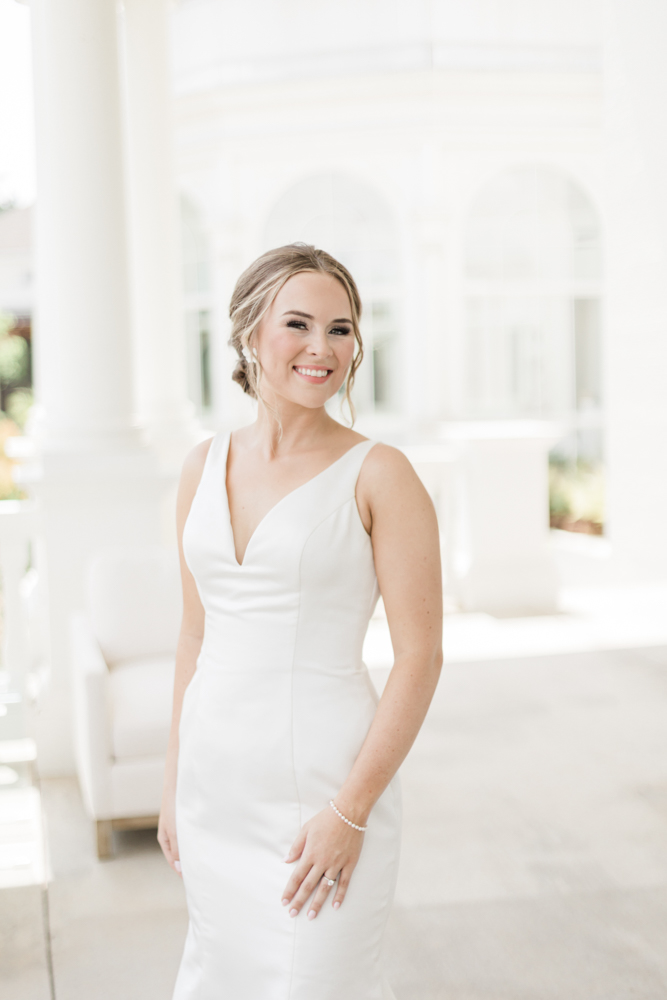 The bride smiles on the veranda at Huntsville Botanical Garden.