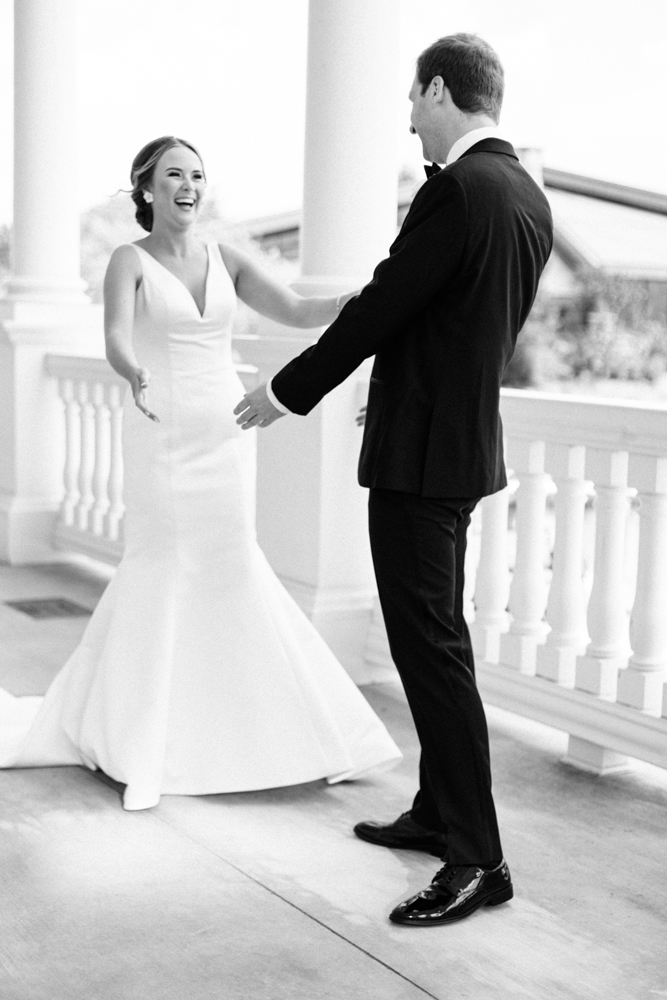 The bride and groom have their first look on the veranda at Huntsville Botanical Garden.