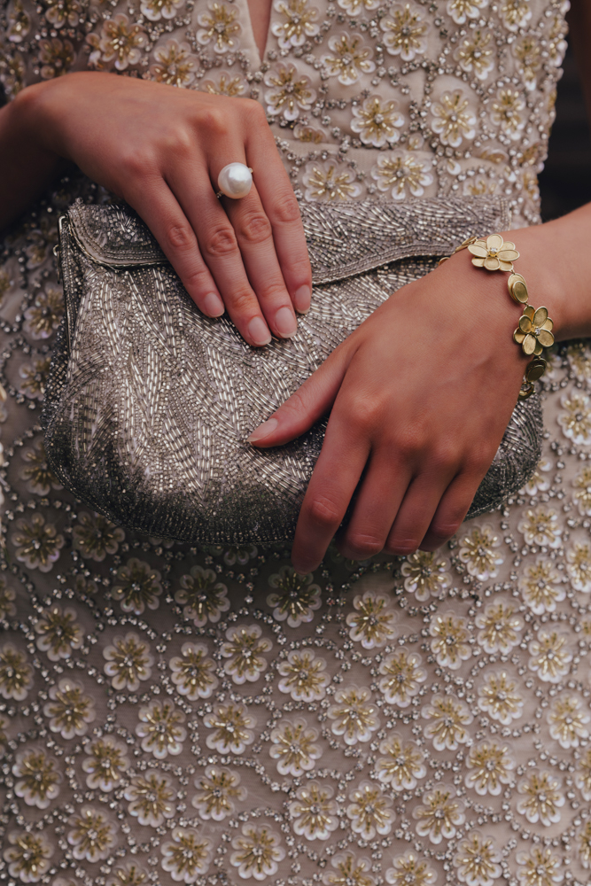 The Alabama wedding guests wears a dress from The Clothes Tree by Deborah Birmingham with a clutch by Rugged and Fancy.