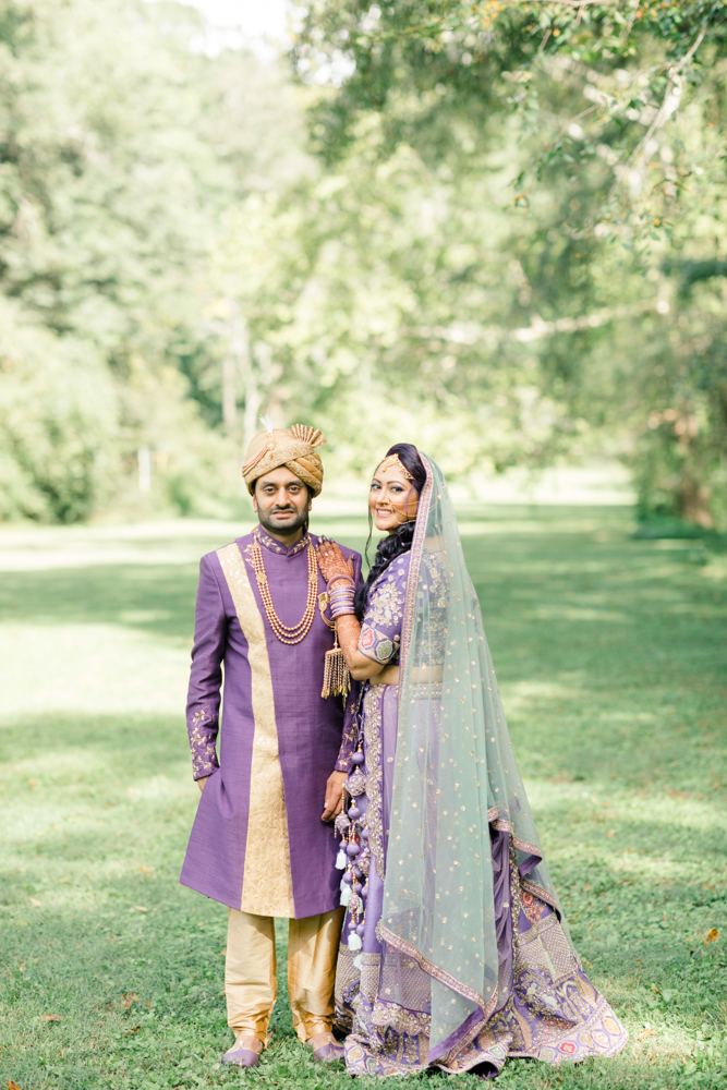 The bride and groom wear traditional Indian attire for their wedding ceremony at Mathews Manor in Springville, Alabama.