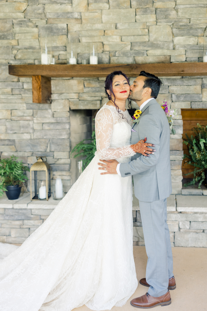 The groom kisses the bride at Mathews Manor in Springville, Alabama.