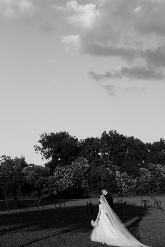 The bride and groom walk together outside the Montgomery Museum of Fine Arts for their Alabama wedding.