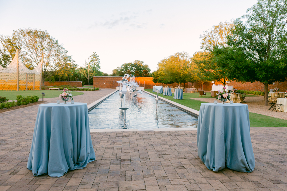 The outdoor reception at Montgomery Museum of Fine Arts is set with cocktail tables and dining al fresco.