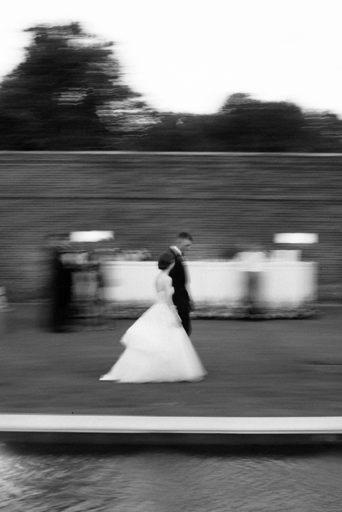 Mo Davis Photography captures the bride and groom walking across the lawn at Montgomery Museum of Fine Arts.