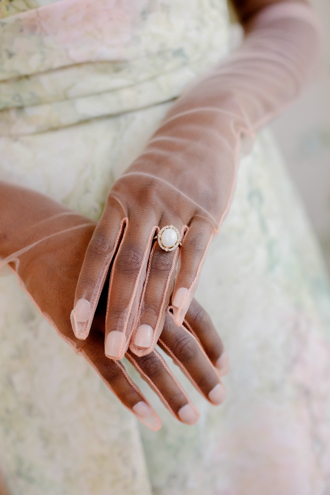 The Southern bride wears pink tulle gloves with her wedding dress in Alabama.