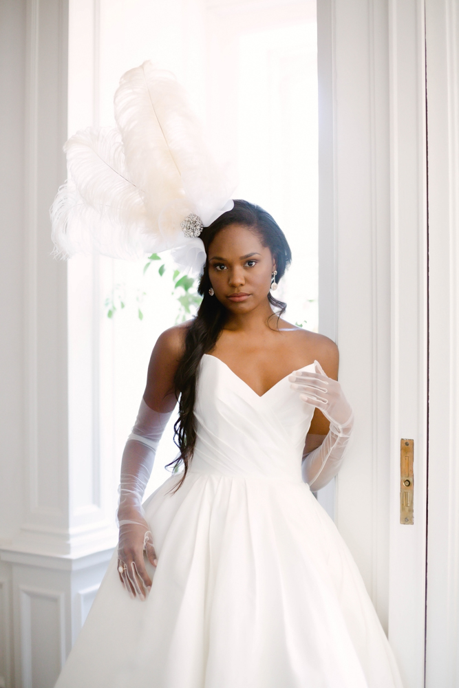 The Southern bride wears a dress and feather headpiece from The White Room Bridal Salon in Birmingham.