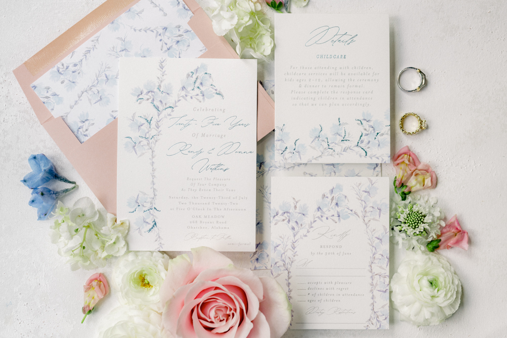 The wedding invitations are styled in a lay flat for this Oak Meadow Event Center wedding in Ohatchee, Alabama.