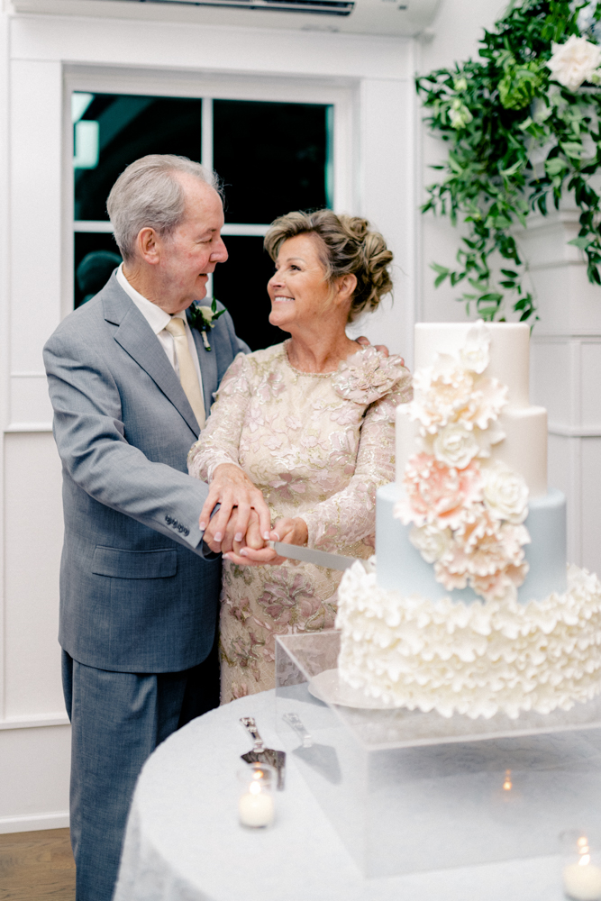 The couple cuts the wedding cake at their Southern vow renewal ceremony.