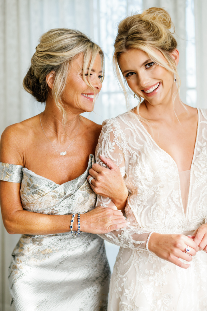 The bride and mother of the bride share a moment together before this Southern wedding.