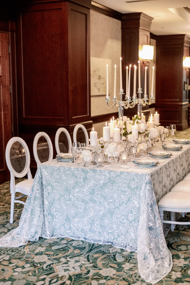 A blue and white winter wedding tablescape is set by Anna Wynn Event Designs.
