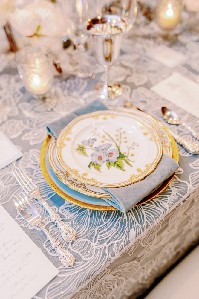 Family heirloom place settings from Anna Wynn Event Designs fit the white and blue scheme of this winter tablescape.