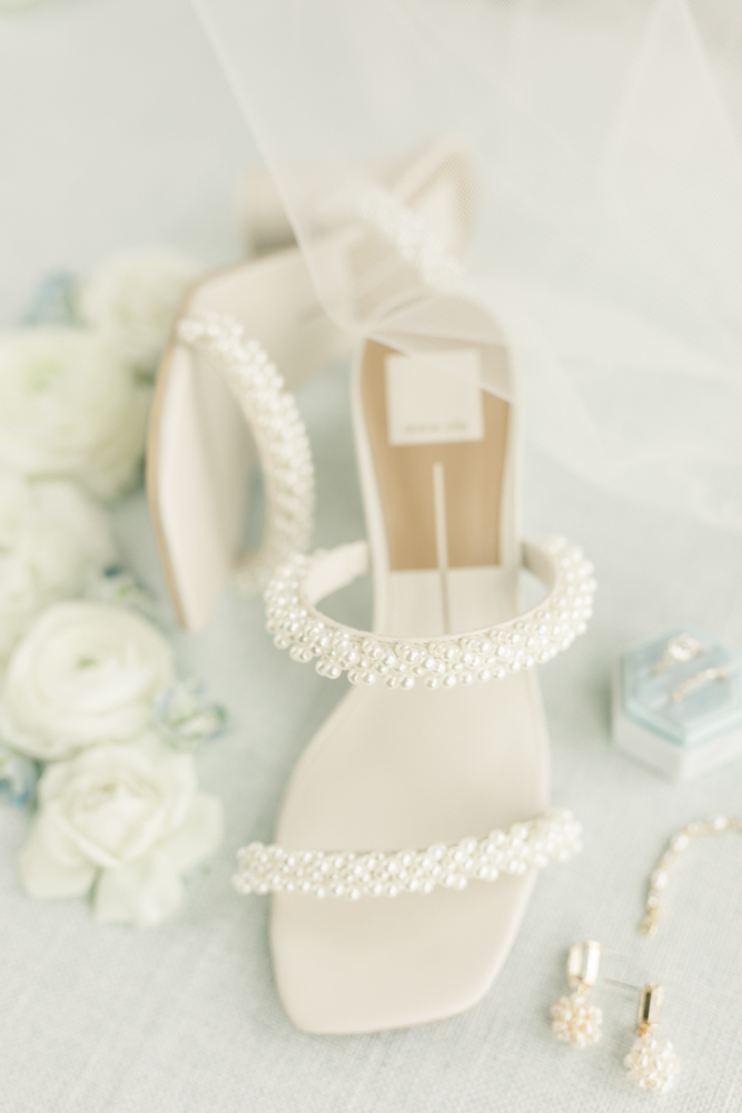 The bridal shoes are photographed with her jewelry for her Alabama wedding.