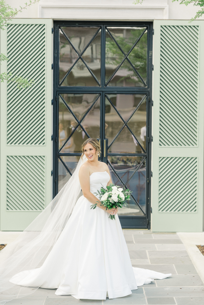 The bride stands in front of The Farrell before her Alabama wedding ceremony.